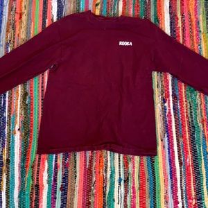 A maroon long sleeve shirt